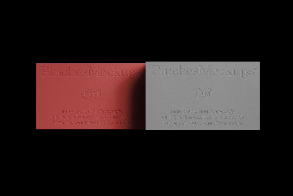 Elegant embossed paper mockup in red and grey, showcasing high-resolution textures and shadows, perfect for realistic brand presentation designs.