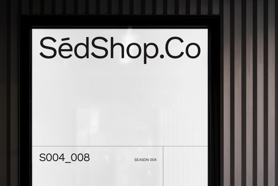 Minimalist storefront mockup with bold typography for logo display, framed by striped wall decor, ideal for branding projects.