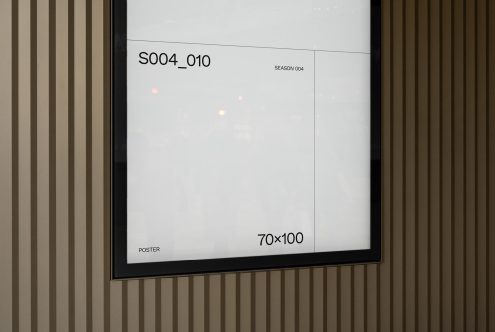 Minimalistic poster mockup hanging on a striped wall in a modern setting, displaying dimensions 70x100, ideal for designers' presentations.