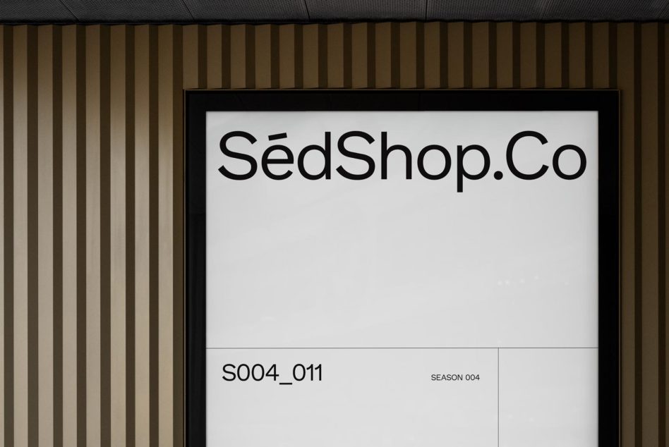 Storefront signboard mockup with modern font design on a striped wallpaper background, suitable for branding and logo design presentation.