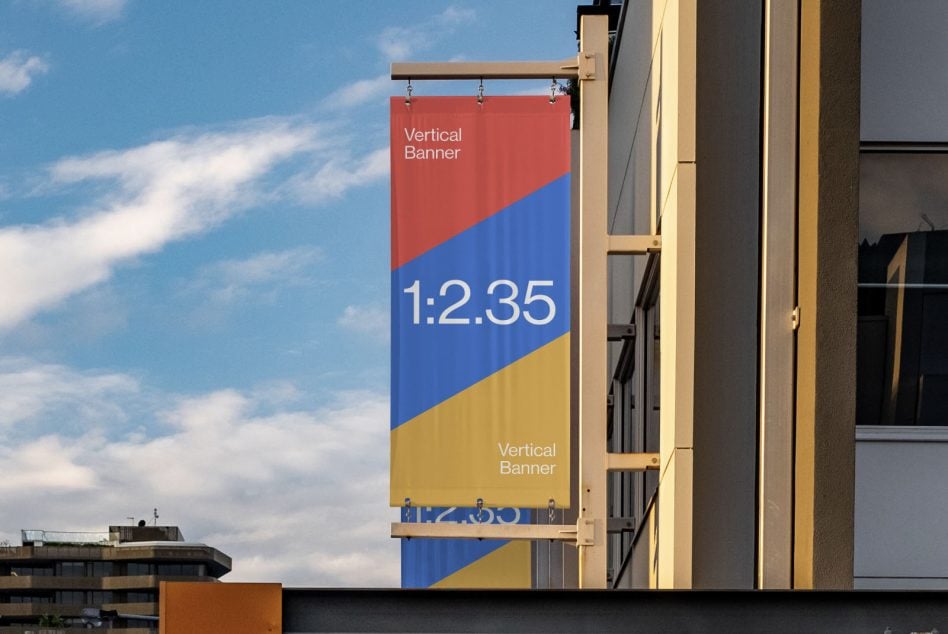 Vertical banner 1:2.35 mockup on building facade with colorblock design in red, blue, yellow