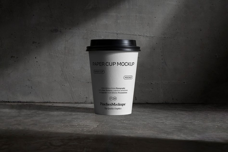 Realistic paper cup mockup on textured background for brand presentations and design mockups, ideal for graphic designers and portfolio showcases.