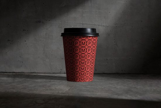 Disposable coffee cup mockup with red pattern design on concrete background, ideal for presenting branding projects for designers.