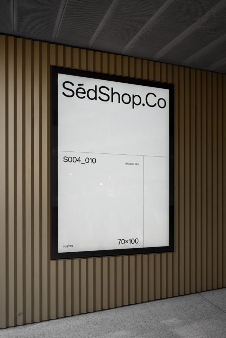 Poster mockup in a modern urban setting, showing a storefront advertisement with sleek design and clean font for graphic designers.