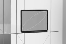 Tablet on grid wall showing neutral gray screen with white curved line element