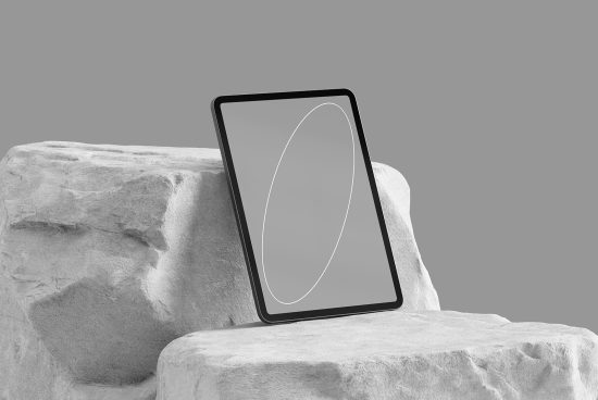 Sleek tablet mockup leaning on a textured rock with a blank screen, ideal for presenting app designs and interface layouts.