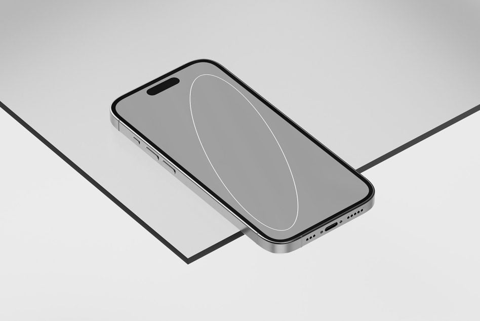 Smartphone mockup with gray screen on dark surface, angled shot