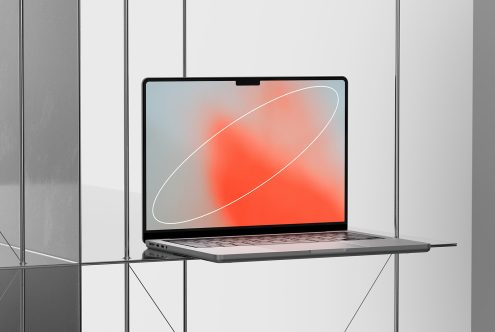 Laptop on glass table with red overlay design screen for digital Mockups, sleek modern computer for graphic design display.