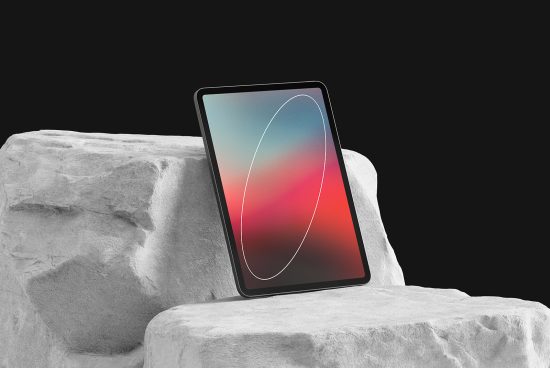 Modern tablet mockup on a textured rock surface with abstract screen design, ideal for showcasing UI/UX graphics and digital presentations.