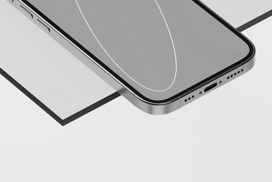 Smartphone with blank screen sitting on white surface, side view