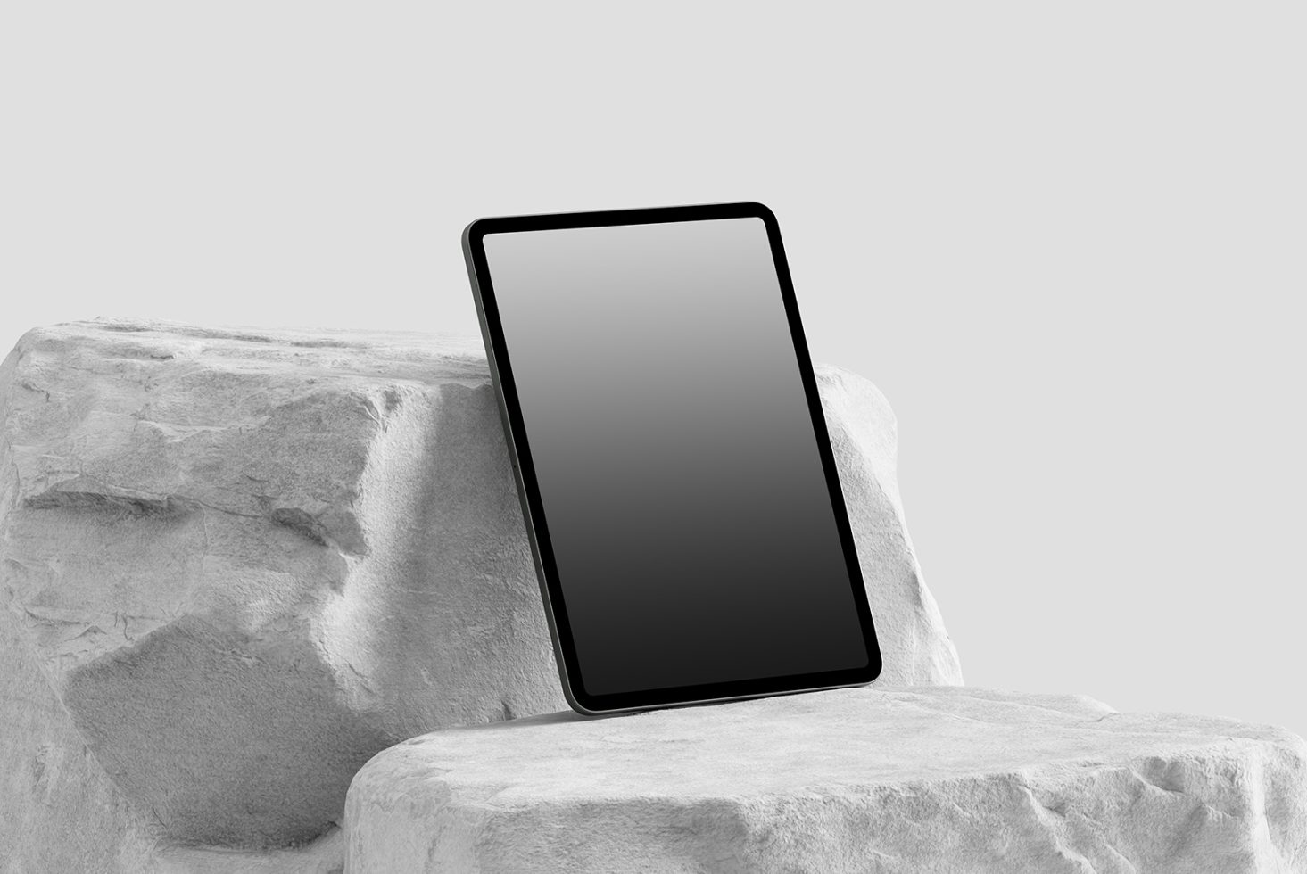 Modern tablet mockup on a textured stone surface, minimalistic design, isolated object for digital product display.