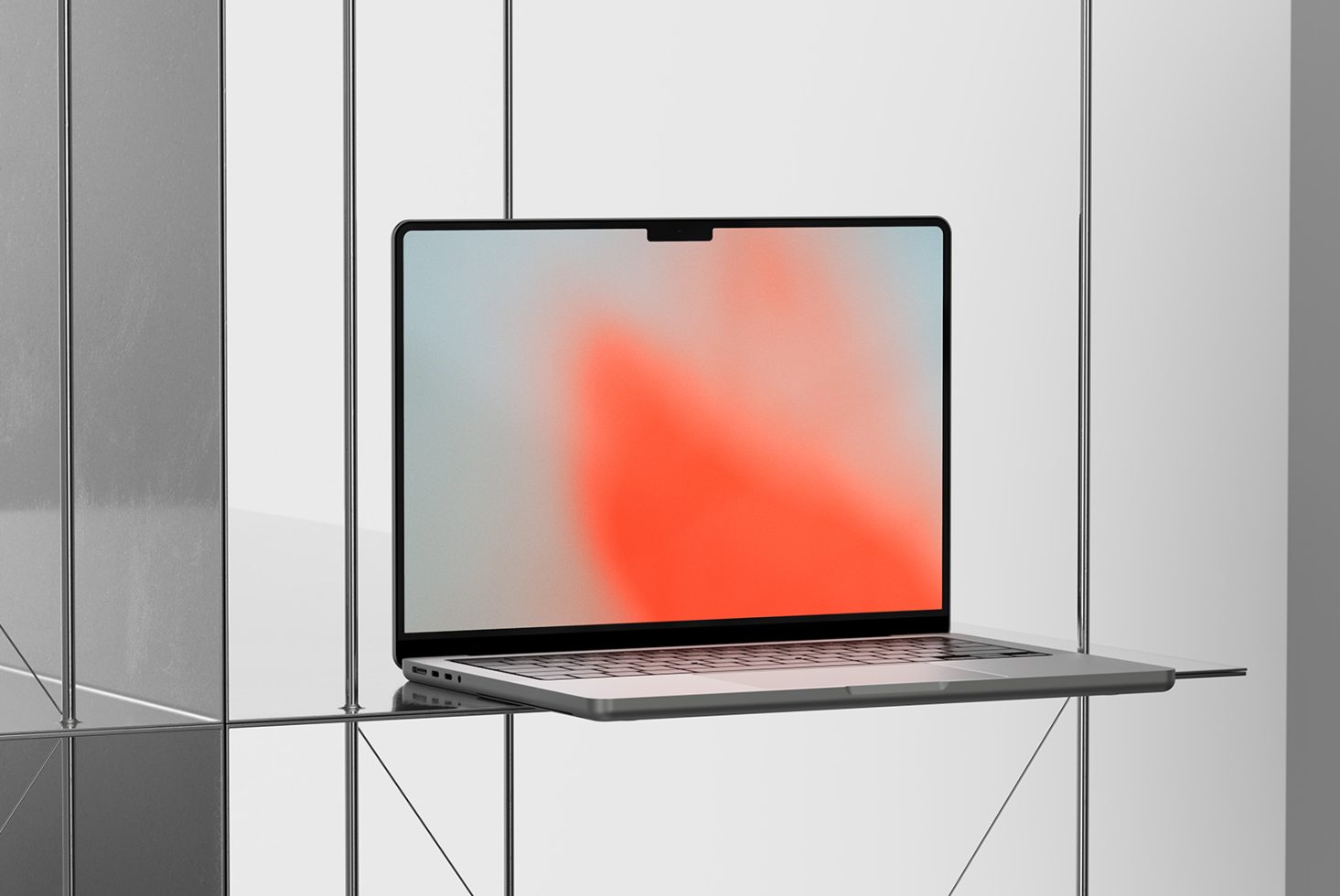 Laptop on glass shelf showing coral gradient background