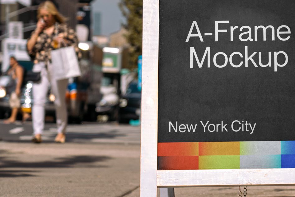 A-frame sidewalk sign on busy street with blurred pedestrians in background