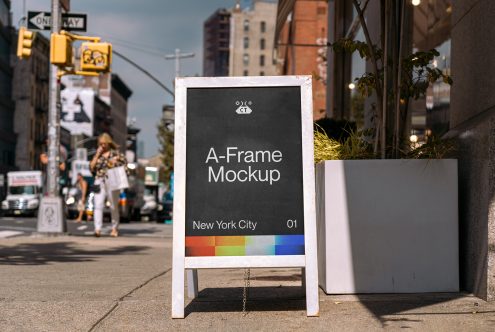 White A-frame sandwich board with dark display sitting on street corner