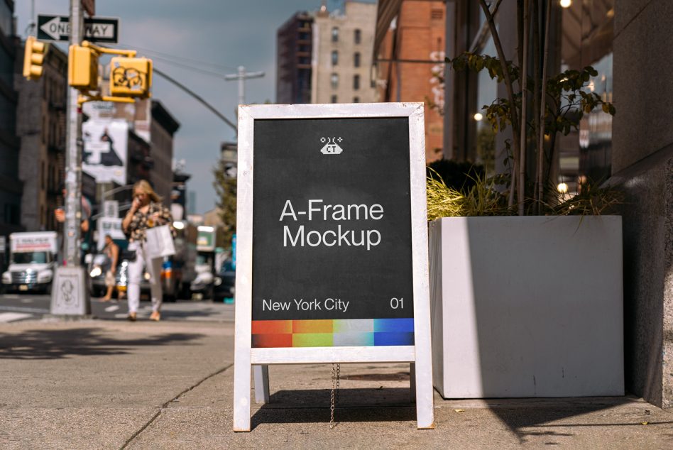 White A-frame sandwich board with dark display sitting on street corner