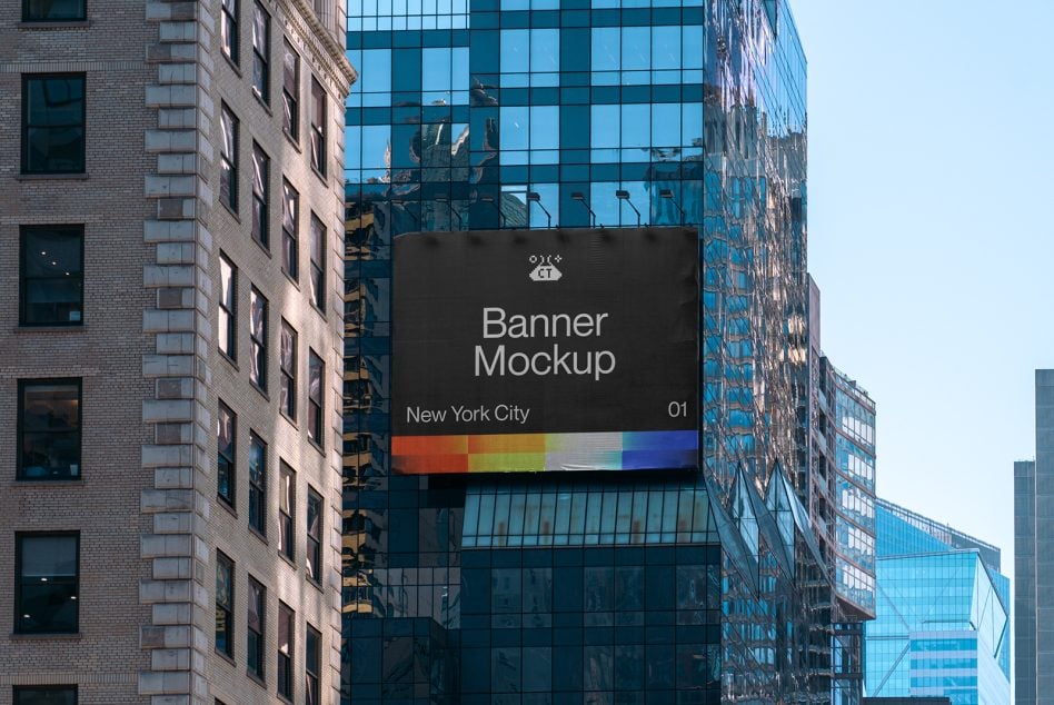 Black urban billboard between brick towers with colorful gradient stripe