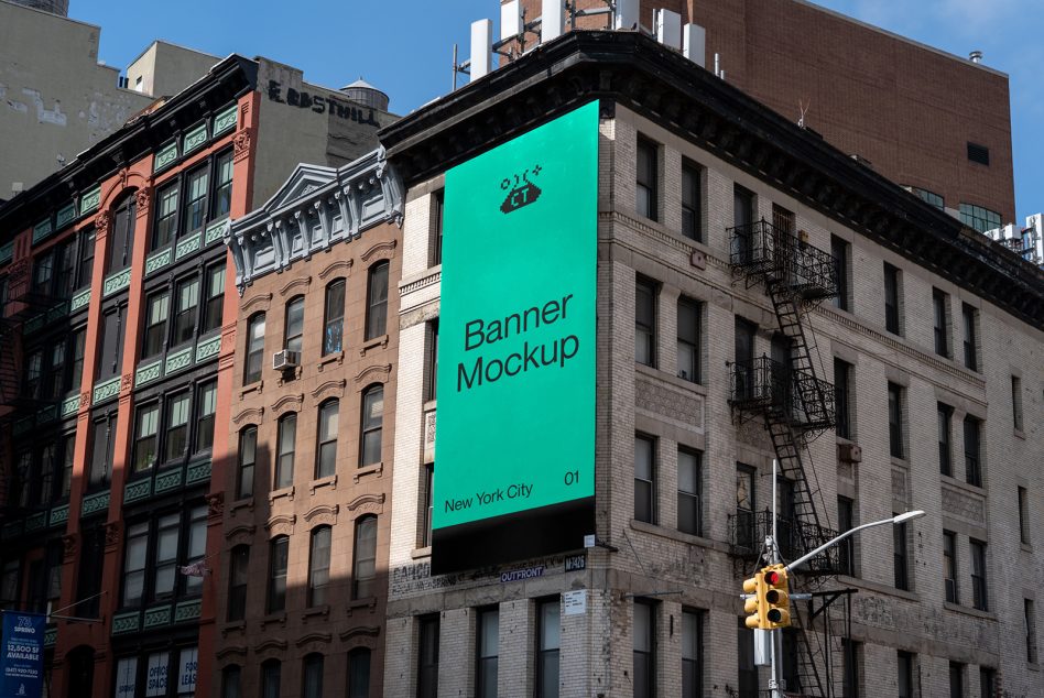 Bright turquoise banner on NYC building with black text below yellow traffic light
