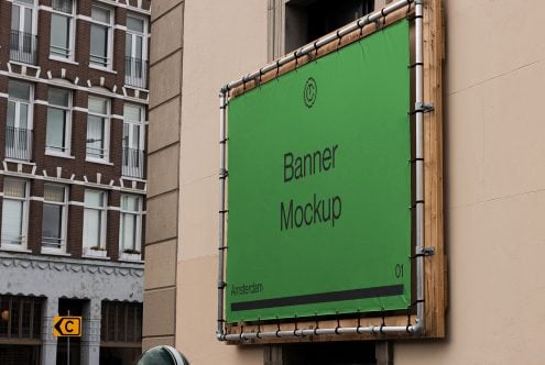 Bright green fabric banner mockup stretched on wooden frame on stone building