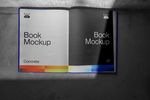 Open book with blue spine showing white left page, black right page, color bar at bottom