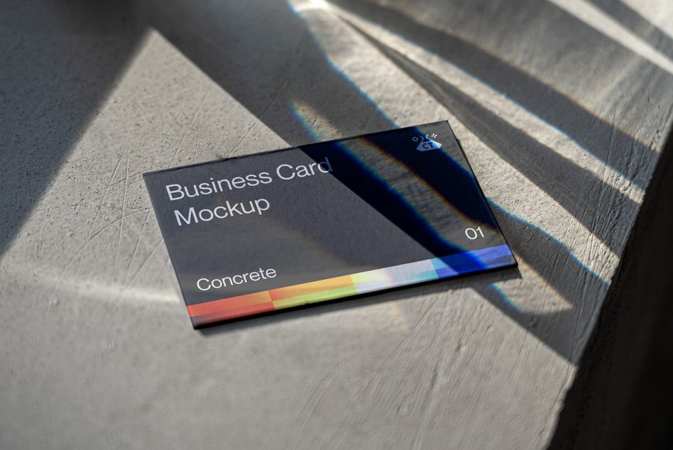 Dark business card with colorful stripe on wood in natural sunlight with prism effects