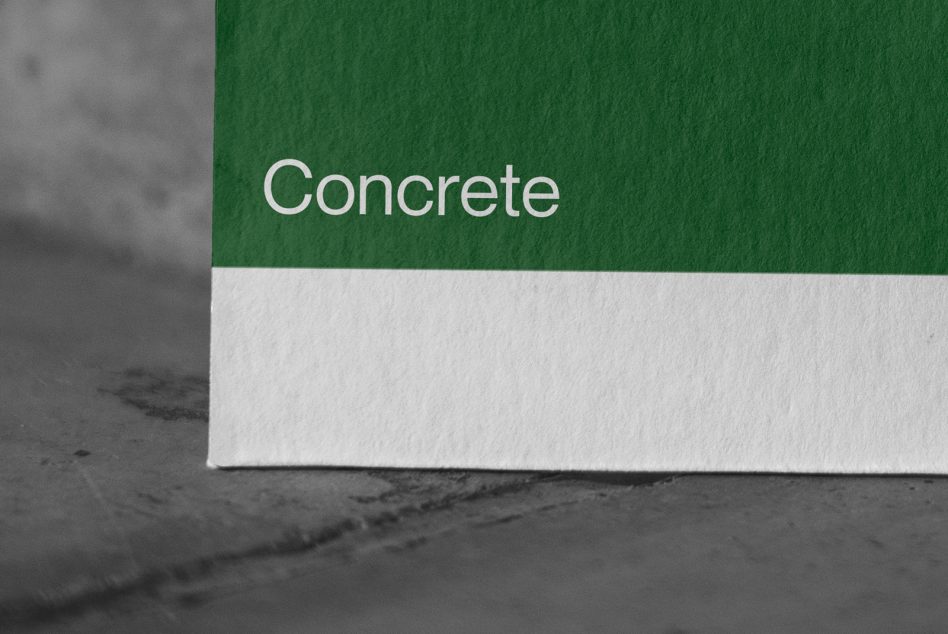 White text reading Concrete on green paper surface with white edge on dark background