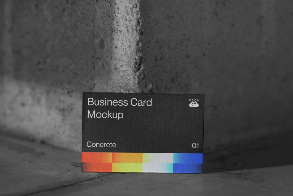 Dark business card mockup leaning on concrete edge with rainbow color bar below