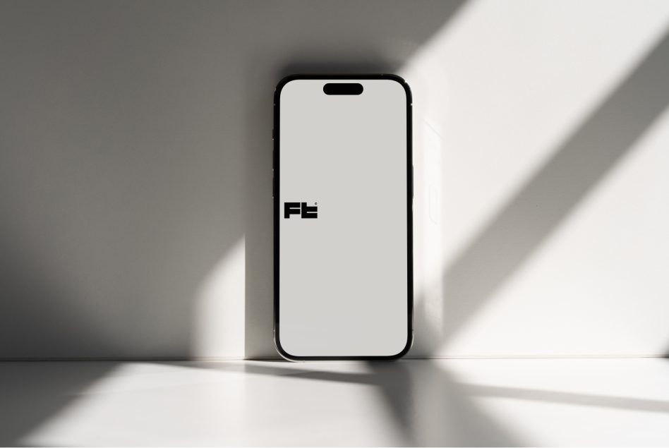 iPhone centered on white floor with geometric shadow patterns