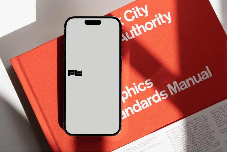 iPhone 14 Pro mockup next to red brand guidelines manual with sunlight