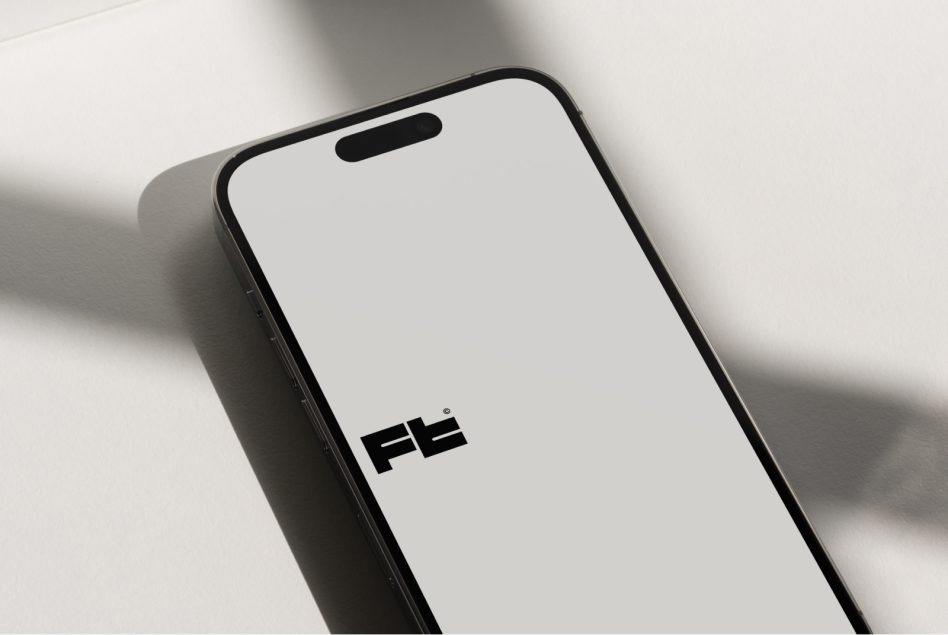 Black smartphone with blank screen showing brand logo on white surface