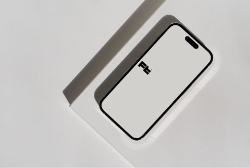 iPhone 14 Pro mockup diagonal layout on white surface with neutral paper accent