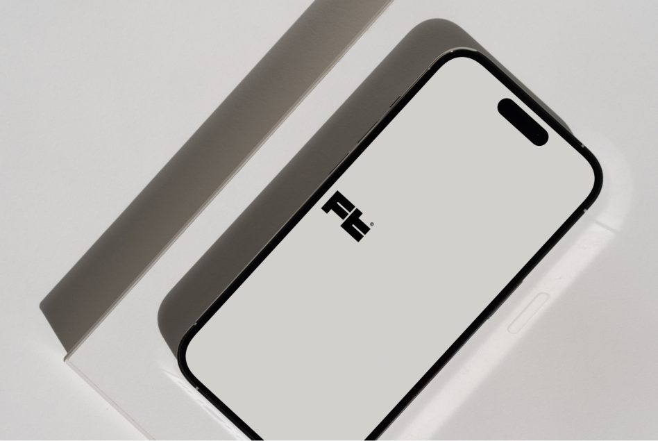 iPhone 14 Pro mockup at angle on white backdrop with gray paper strip