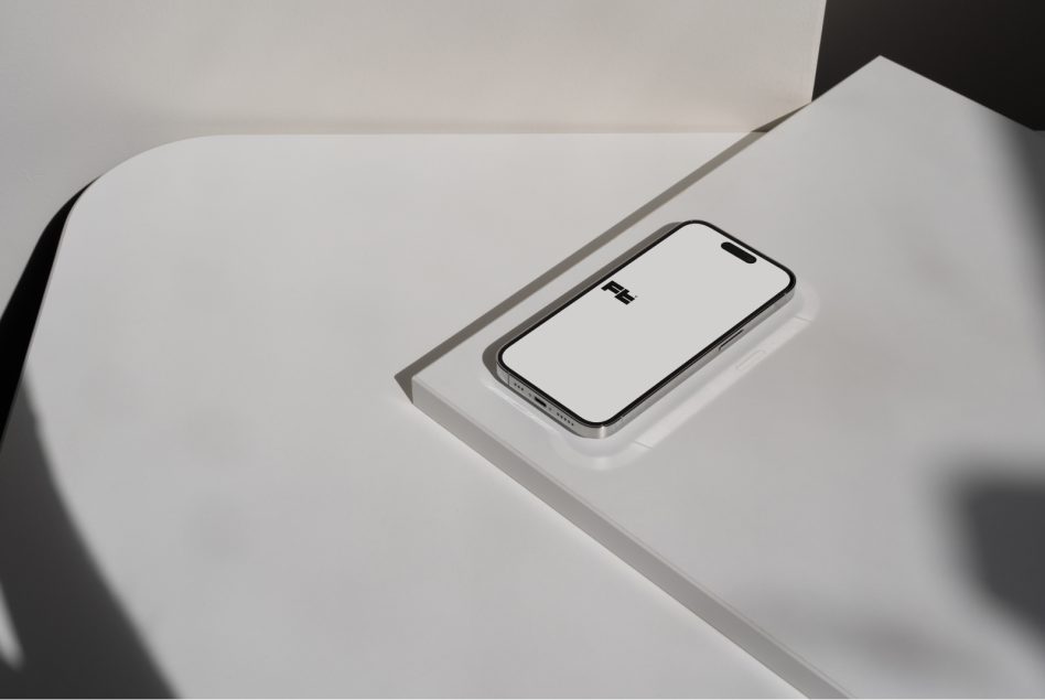 iPhone 14 Pro mockup on curved white surface, angled view, empty screen