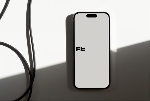Mobile device mockup next to curved plant stems on surfaces