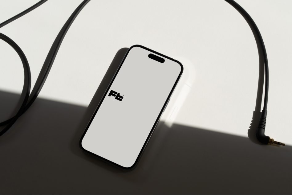 Phone mockup with 3.5mm jack headphones in moody studio lighting