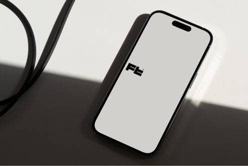 iPhone mockup with headphones on angled surface, shadow detail