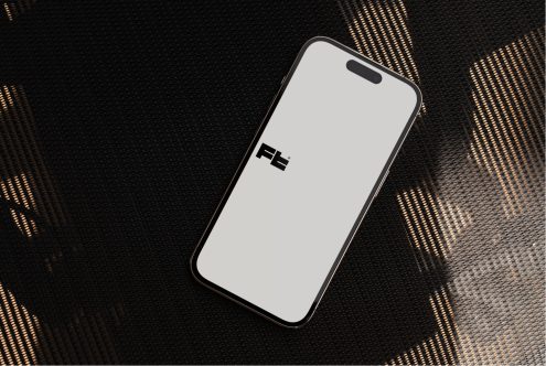 Black phone mockup on dark fabric with golden geometric light pattern backdrop
