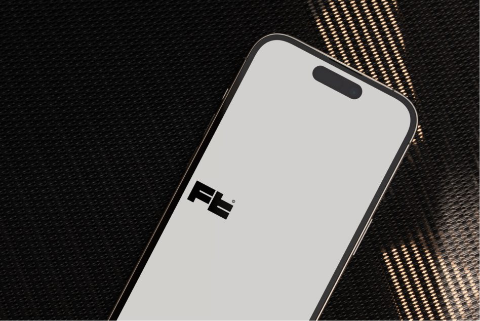 Smartphone with blank screen on textured dark surface with gold pattern overlay