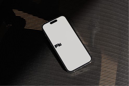 iPhone 14 Pro flat lay on dark textile with gold dotted accent lighting