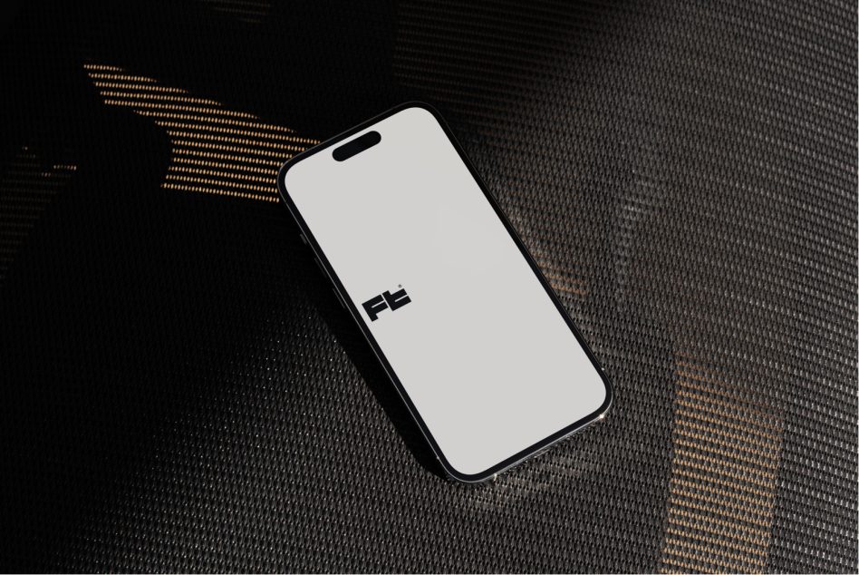 iPhone 14 Pro flat lay on dark textile with gold dotted accent lighting