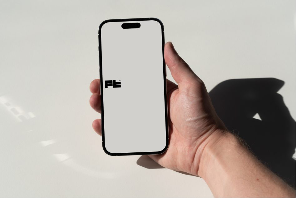 iPhone 14 Pro mockup in hand against minimal beige backdrop