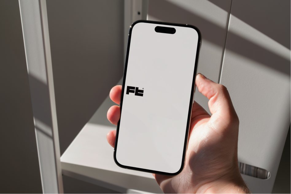 iPhone 14 Pro in hand displaying white screen, soft studio lighting