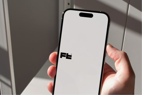 iPhone 14 Pro mockup held in hand with blank screen, natural window light