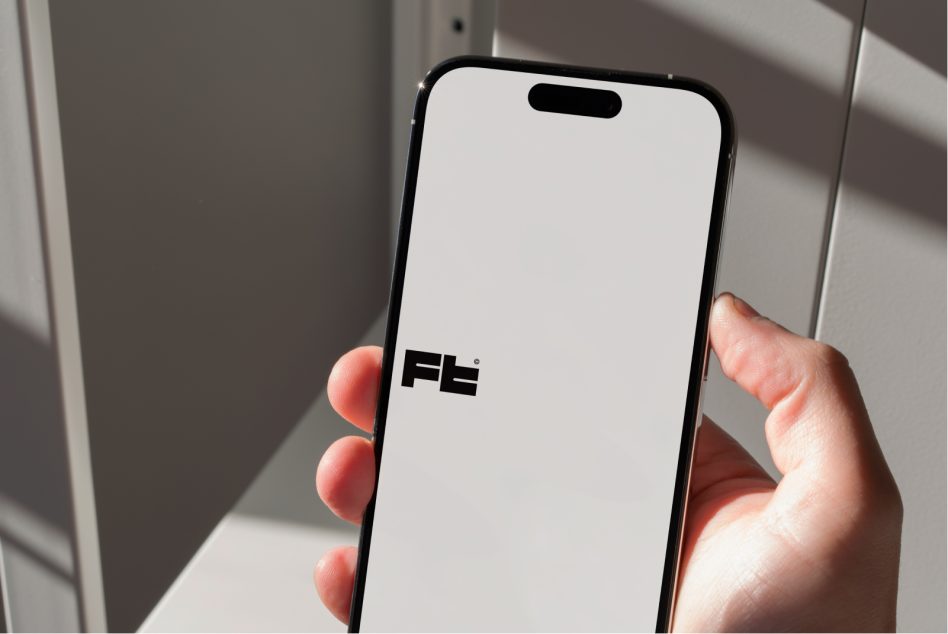 iPhone 14 Pro mockup held in hand with blank screen, natural window light