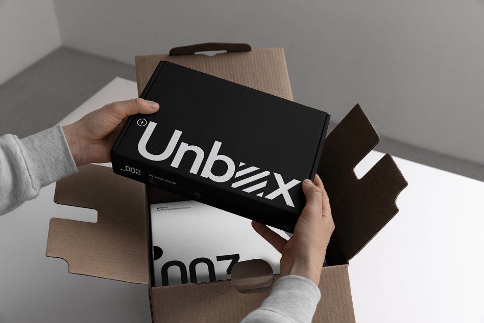 Person holding a stylish shoebox design with bold typography mockup for packaging presentation, showcasing modern branding concept for designers.