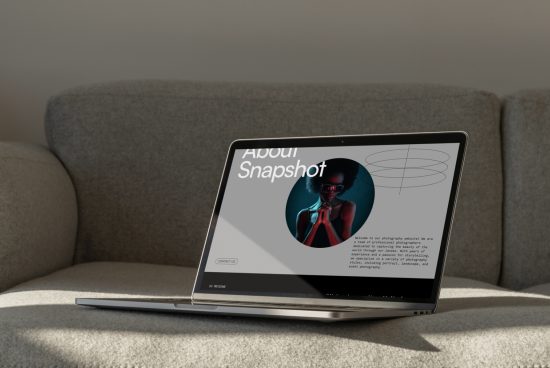 Laptop on a sofa displaying a photography portfolio website template with a dark-themed model image, ideal for designers looking for modern web templates.