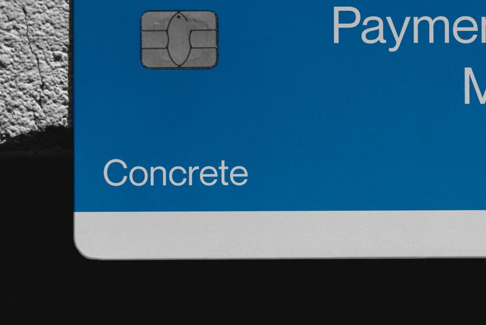Blue payment card detail showing chip area against textured wall
