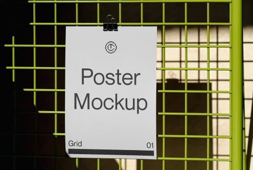 White poster clipped to neon yellow grid frame showing placeholder text