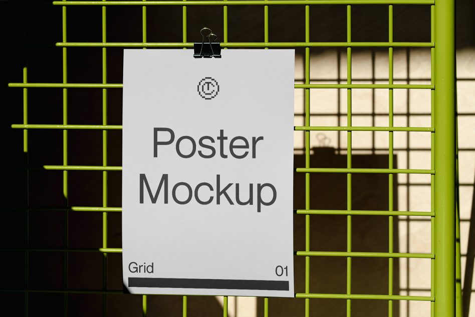 White poster clipped to neon yellow grid frame showing placeholder text