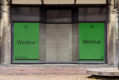Split storefront with two green windows separated by metal blinds centerpiece