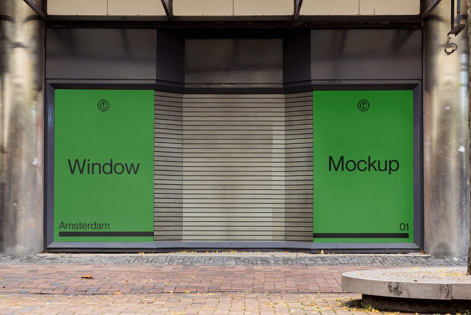 Split storefront with two green windows separated by metal blinds centerpiece